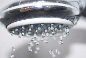 The shower head drips close up