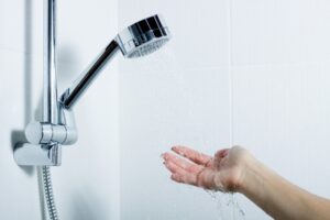 showerhead-hand-reaching-out